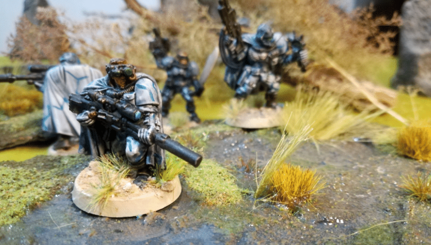 Scout/snipers from the Shadow Serpents legion maneuver through a swamp.