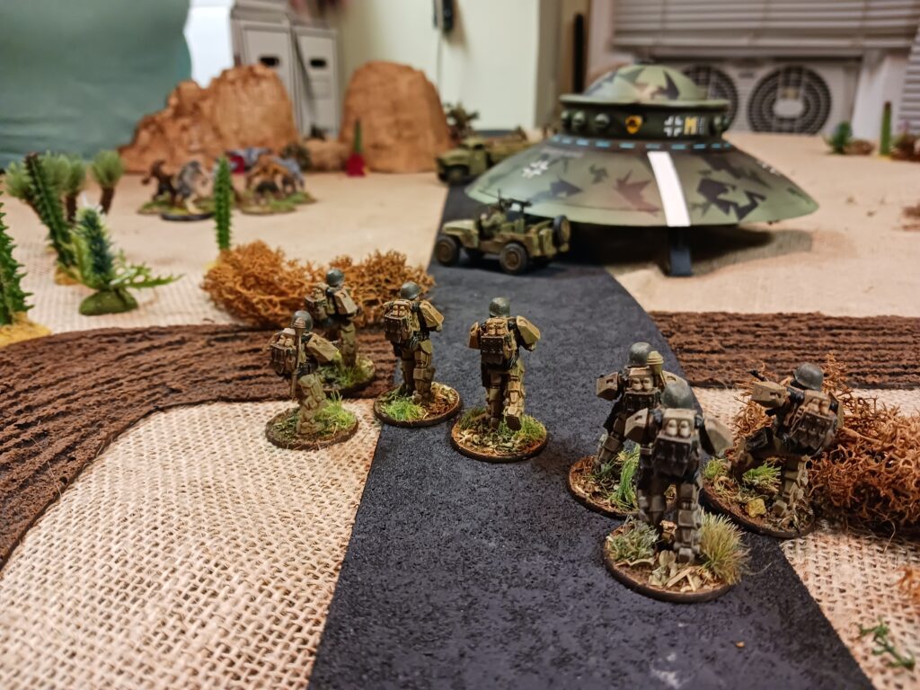 German powered armor troops advance to recapture a disabled Haunebu II flying saucer in a game of Konflikt 47