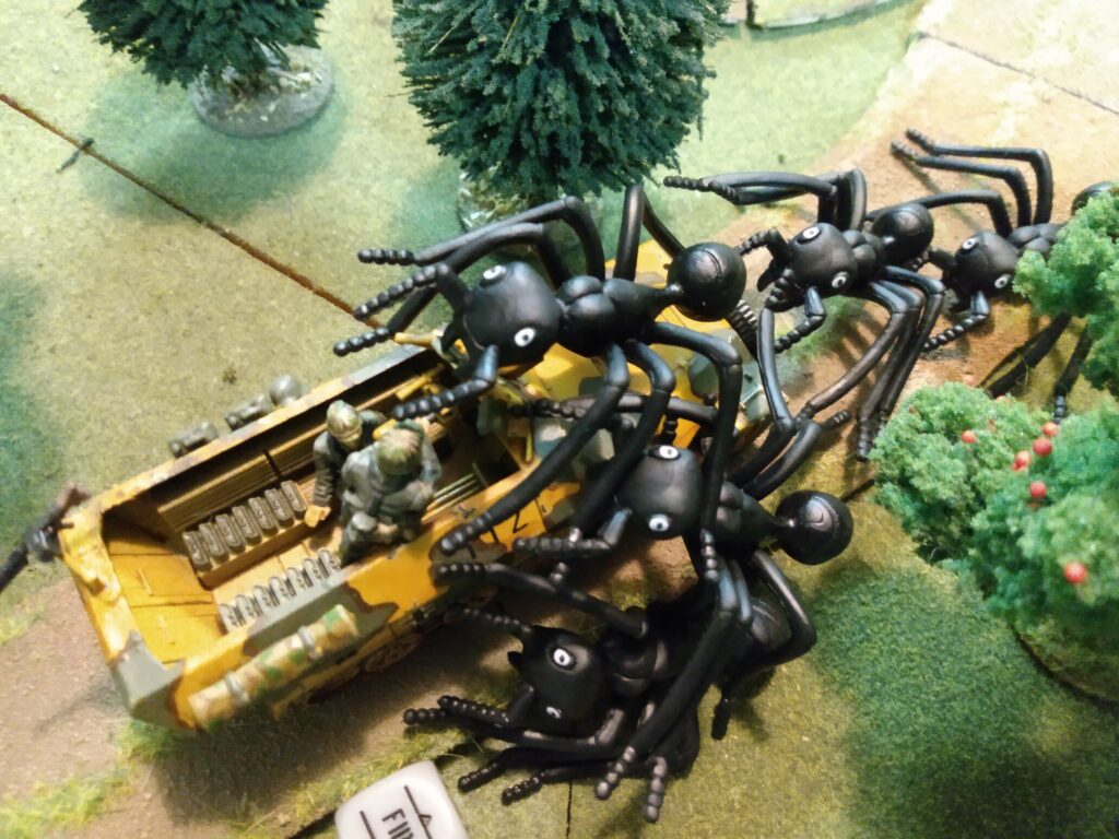 Giant ants swarm a German halftrack in a Weird World War Two wargame.