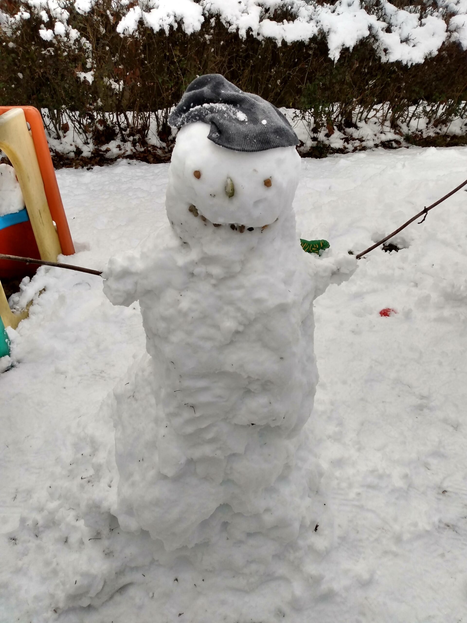 A friendly snowman with outstretched arms.